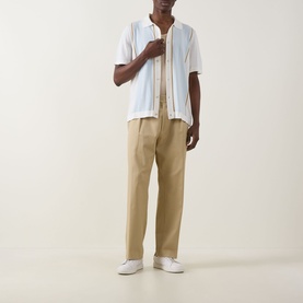 Model wearing Boss Black Casual Lastro Colour-Blocked Shirt in Open White with beige trousers and white trainers.