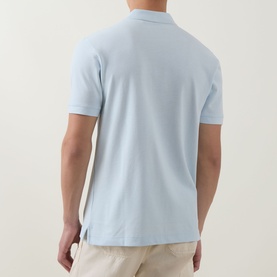 Model wearing Boss Black Casual Open Blue cotton polo shirt, rear view, styled with stone chinos