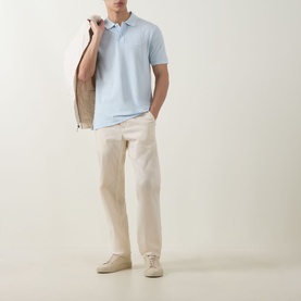 Model wearing Boss Black Casual Open Blue cotton polo shirt, styled with cream trousers and suede desert boots