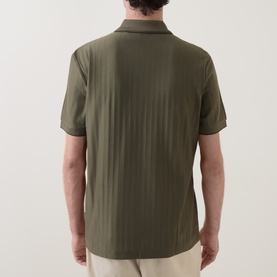 Model wearing Boss Black Casual Parlay Polo Shirt in Open Green, rear view showing textured finish, polo collar, and short sleeves with contrast