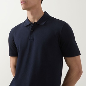 Model wearing Boss Black Casual Parlay Logo Polo Shirt in dark blue, featuring polo collar, two-button placket and short sleeves