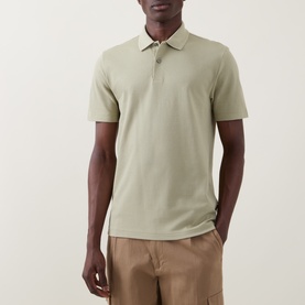 Model wearing Boss Black Casual dark beige cotton polo shirt with classic collar and short sleeves, styled with beige trousers