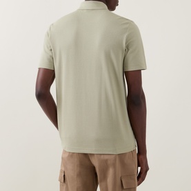 Model wearing Boss Black Casual dark beige cotton blend polo shirt, back view, styled with khaki cargo trousers.