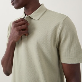 Model wearing Boss Black Casual dark beige textured cotton polo shirt, close-up showing zip placket and structured collar detail