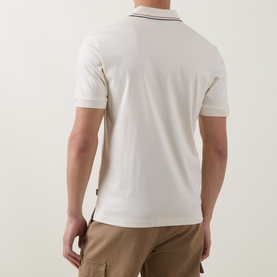 Model wearing Boss Black Casual Penrose Tipped Logo Polo Shirt in Open White, back view showing tipped stripe collar and short sleeves, styled with