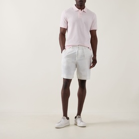 Model wearing Boss Black Casual Peter C Drawstring Shorts in Open White, styled with a pink polo shirt and white trainers