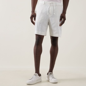 Model wearing Boss Black Casual Peter C Drawstring Shorts in Open White, styled with white low-top trainers
