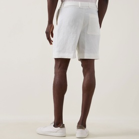 Model wearing Boss Black Casual Peter C Drawstring Shorts in Open White linen blend, rear view, styled with white trainers