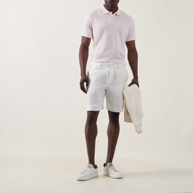 Model wearing Boss Black Casual Peter C Drawstring Shorts in Open White, styled with a pink polo shirt and white trainers