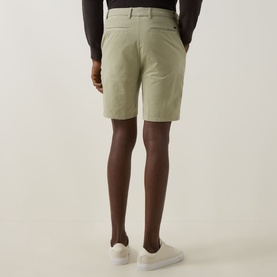 Model wearing Boss Black Casual Kane Chino Shorts in Dark Beige, slim-leg with belt loops, paired with white trainers, rear view