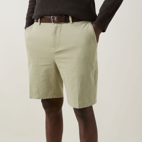 Model wearing Boss Black Casual Kane Chino Shorts in Dark Beige, slim-leg, mid-rise, styled with a brown leather belt and dark grey top.