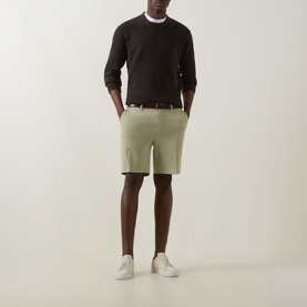 Model wearing Boss Black Casual Kane Chino Shorts in Dark Beige, slim-leg, styled with dark sweatshirt, brown belt and white trainers
