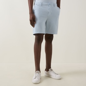 Model wearing Boss Black Casual Open Blue cotton-elastane shorts, styled with white trainers. Slim fit with belt loops and zip fly.