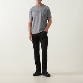 Model wearing Boss Black Casual H-Delaware Slim-Leg Jeans in black with grey crew-neck T-shirt and black leather shoes.