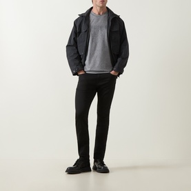 Model wearing Boss Black Casual H-Delaware Slim-Leg Jeans in black, styled with a grey T-shirt and dark jacket.