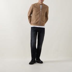 Model wearing Boss Black Casual Charcoal Straight Jeans in dark wash, styled with a camel bomber jacket, white T-shirt, and black shoes.