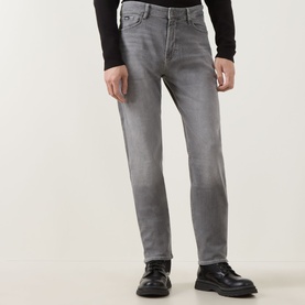 Model wearing Boss Black Casual medium grey straight-leg jeans, styled with black top and black leather shoes.