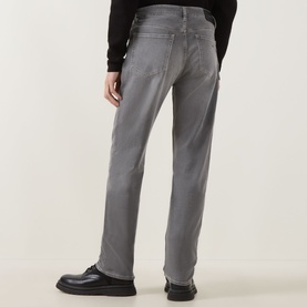 Model wearing Boss Black Casual medium grey straight jeans, rear view, styled with a black top and black leather shoes.