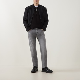 Model wearing Boss Black Casual medium grey straight jeans, styled with black bomber jacket and black leather loafers.