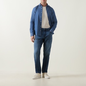 Model wearing Boss Black Casual P-Re.Maine Slim-Leg Jeans in dark blue mid-wash stretch denim, styled with a blue shirt and white trainers.