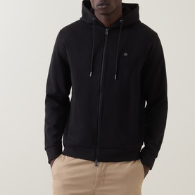 Model wearing Boss Black Casual black zip-through hoodie with small logo embroidery, styled with beige chinos.