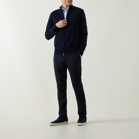 Model wearing Boss Black Casual Balonso Logo Zip Sweater in dark blue, styled with navy trousers and blue shirt