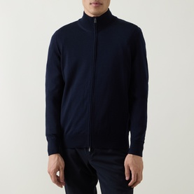 Model wearing Boss Black Casual Balonso Logo Zip Sweater in dark blue, mock neck, two-way zip, ribbed trims, styled with navy trousers