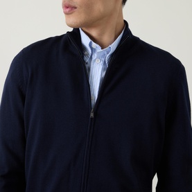 Model wearing Boss Black Casual Balonso Logo Zip Sweater in dark blue, mock neck, full zip, styled over light blue striped shirt.