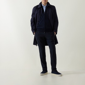 Model wearing Boss Black Casual Balonso Logo Zip Sweater in dark blue, styled with navy mac coat, matching trousers and navy trainers.