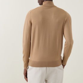 Model wearing Boss Black Casual Balonso Logo Zip Sweater in medium beige, back view, with white trousers. Fine-knit, mock neck, long sleeves.