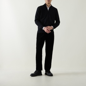Model wearing Boss Black Casual Balonso Logo Zip Sweater in black with dark trousers and black leather shoes.