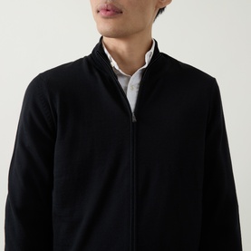 Model wearing Boss Black Casual Balonso Logo Zip Sweater in black, featuring mock neck, two-way front zip, and ribbed trims, styled over white shirt.