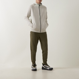 Model wearing Boss Green Label Light Beige casual zip-through hoodie jacket with olive joggers and chunky trainers.