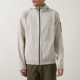 Model wearing Boss Green Label Light Beige casual jacket with hood, zip fastening and sleeve pocket, styled with olive trousers.