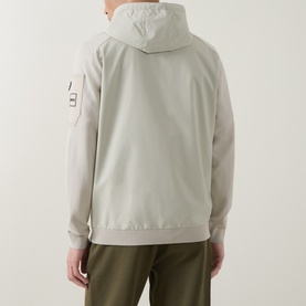 Model wearing Boss Green Label Light Beige casual jacket, back view, with hood and arm patch detail, styled with olive trousers