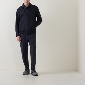 Model wearing Boss Green Label dark blue casual jacket with matching trousers and grey trainers, full-length view