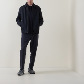 Model wearing Boss Green Label dark blue casual jacket with matching navy trousers and grey trainers