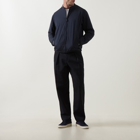 Model wearing Boss Green Label dark blue casual jacket with zip front, styled with black trousers and beige shoes