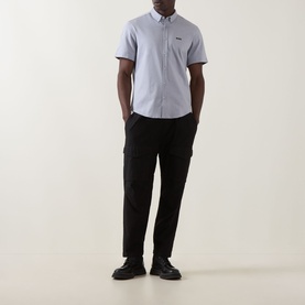 Model wearing Boss Green Label dark grey short-sleeve casual shirt with black cargo trousers and black shoes.