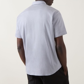 Model wearing Boss Green Label dark grey cotton casual shirt, rear view, short sleeves, relaxed fit, paired with black trousers