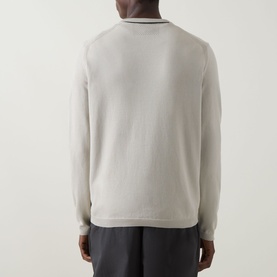 Model wearing Boss Green Label Ever-X Logo Sweater in light beige, back view, showing contrast tipping at crew neck and cuffs, paired with dark