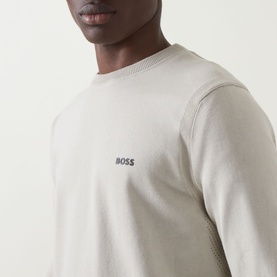 Model wearing Boss Green Label Ever-X Logo Sweater in Light Beige with contrast logo detail and ribbed crew neckline
