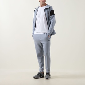 Model wearing Boss Green Label Contrast Insert Active Logo T-Shirt in White, styled with grey zip hoodie, matching joggers and grey trainers.