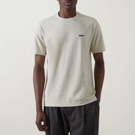Model wearing Boss Green Label Swing Printed Logo T-Shirt in light beige, crew neck, short sleeves, contrast logo chest print, styled with dark