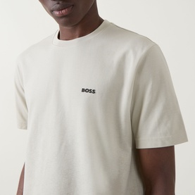 Model wearing Boss Green Label Swing Printed Logo T-Shirt in Light Beige, crew neck, short sleeves with contrast chest logo.