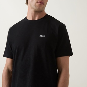 Model wearing Boss Green Label black crew neck T-shirt in 100% cotton, with small white BOSS logo on chest.