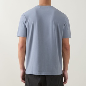 Model wearing Boss Green Label dark grey crew neck T-shirt, rear view, styled with dark trousers.