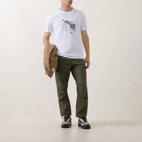 Model wearing Boss Green Label white crew neck T-shirt with graphic print, styled with olive cargo trousers and hiking boots, jacket draped over