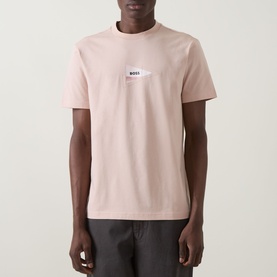 Model wearing Boss Green Label Light/Pastel Orange crew neck T-shirt with chest logo patch, styled with dark shorts.