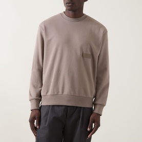 Model wearing Boss Green Label SW Logo Patch Sweatshirt in Light Pastel Green, crew neck with chest patch detail, styled with dark trousers